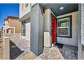 Inviting front porch area featuring a red front door and stylish tiled entryway at 3725 Celesta Vista Ave, Henderson, NV 89044