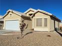Charming single-story home with desert landscaping and a neutral-colored exterior at 3836 Quail Creek Dr, North Las Vegas, NV 89032