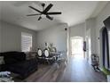 Open-concept living room and dining area with vaulted ceilings and modern decor at 3836 Quail Creek Dr, North Las Vegas, NV 89032
