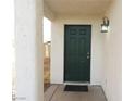 Inviting front entrance with a classic dark green door and decorative lighting fixture at 3916 Via Lucia Dr, Las Vegas, NV 89115