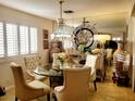 Elegant dining room featuring a glass table, chandelier, and mirrored accent wall at 4019 Delos Dr, Las Vegas, NV 89103