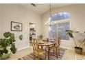 Cozy dining room with a chandelier and an adjacent kitchen creates a comfortable space at 422 Tanita Ct, Las Vegas, NV 89123