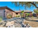 Landscaped front yard with an ornamental bridge and desert landscaping at 430 Wickenburg St, Henderson, NV 89015
