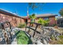 Front yard with decorative bridge, native plants, and rock features at 430 Wickenburg St, Henderson, NV 89015