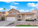 Two-story home featuring desert landscaping, an attached two-car garage, and a tile roof at 5000 Forest Oaks Dr, Las Vegas, NV 89149
