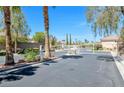 Gated community entrance with palm trees and well-maintained landscaping at 5218 Blue Gum Ct, Las Vegas, NV 89148