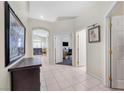 Bright hallway with tile flooring, arched doorways, and views of adjacent rooms at 5218 Blue Gum Ct, Las Vegas, NV 89148