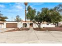 Single-story home featuring desert landscaping, a spacious driveway, and a two-car garage at 5248 W Lake Mead Blvd, Las Vegas, NV 89108