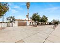Expansive driveway leading to a single-story home with desert landscaping and a two-car garage at 5248 W Lake Mead Blvd, Las Vegas, NV 89108