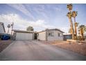 Exterior showcasing the home's single-story design, driveway, and desert landscaping at 5408 Longridge Ave, Las Vegas, NV 89146