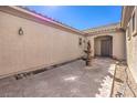 Private courtyard featuring a decorative fountain and a neutral color scheme at 5525 Criollo Dr, Las Vegas, NV 89122