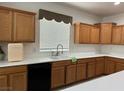 Bright kitchen with wood cabinetry, black appliances, and white countertops at 5525 Criollo Dr, Las Vegas, NV 89122