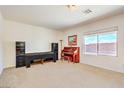 Bright living room featuring neutral carpet and large window with views of the outside at 5525 Criollo Dr, Las Vegas, NV 89122