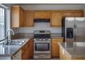 Kitchen featuring granite countertops, stainless steel appliances and wooden cabinets at 6276 Back Woods Rd, Las Vegas, NV 89142