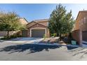 Attractive two-story house with a three-car garage, mature trees, and well-kept landscaping at 6470 Crest Estates St, Las Vegas, NV 89131