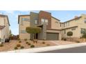 Modern home featuring a two-car garage, neutral-colored exterior, and well-maintained desert landscaping at 6901 Whisper Canyon Pl, North Las Vegas, NV 89084
