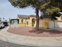 Single-story home featuring a two-car garage and a low-maintenance front yard, offering curb appeal at 6908 Fruit Flower Ave, Las Vegas, NV 89130