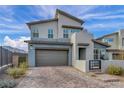 Contemporary two-story home with desert landscaping, brick driveway, and mountain views at 705 Carlon Hills Ave, Las Vegas, NV 89138
