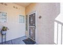 Inviting front door with decorative security screen, sidelight, and tile address plaque at 7400 W Flamingo Rd # 1087, Las Vegas, NV 89147