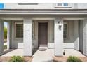 Inviting front porch with sturdy support columns and a stylish, dark front door at 965 Nevada State Dr # 6101, Henderson, NV 89002