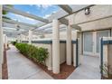 Attractive townhome exterior with a covered walkway, mature shrubs, and neutral colors at , Las Vegas, NV 89117