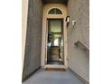 Front entrance showcasing a covered entryway leading to the home's interior, textured walls at 10091 Sand Key St, Las Vegas, NV 89178