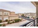 Exterior view from the balcony shows neighboring houses, landscaping, and a well-kept street at 10809 Garden Mist Dr # 2072, Las Vegas, NV 89135