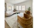 Stylish living room showcasing a modern sofa, chairs, glass coffee table, and natural light at 10809 Garden Mist Dr # 2072, Las Vegas, NV 89135