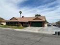 Well-maintained single-Gathering home featuring a two-car garage and a neatly landscaped front yard at 1104 Oak Tree Ln, Las Vegas, NV 89108
