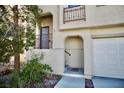 Inviting front entry featuring an arched doorway and second story porch at 1241 Gingerbread Man Ave, Las Vegas, NV 89183