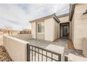 Close up of front door with black metal gate and stylish stone facade at 127 Crimson Cactus Ave, Henderson, NV 89011