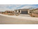 Charming single-story home with a two-car garage and low maintenance desert landscaping at 127 Crimson Cactus Ave, Henderson, NV 89011