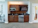 A well-equipped kitchenette boasts modern appliances, wood cabinets, and a sleek design at 135 E Harmon Ave # 2104, Las Vegas, NV 89109