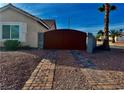 Private backyard featuring a brick-paved driveway and decorative rock landscaping at 1405 Bugle Boy Dr, Henderson, NV 89014