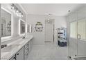 Bright, spacious bathroom with double vanity, modern fixtures, and a glass-enclosed shower at 1405 Bugle Boy Dr, Henderson, NV 89014