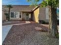 Welcoming front entrance with a mature tree and low-maintenance landscaping at 1405 Bugle Boy Dr, Henderson, NV 89014