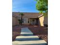 Inviting home entrance with a well-maintained yard and decorative rock features at 1405 Bugle Boy Dr, Henderson, NV 89014