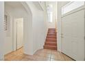 Bright foyer with tile flooring, a staircase leading to the upper level, and ample natural light at 1712 Warrenville St, Las Vegas, NV 89117