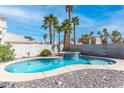 Sparkling pool and spa surrounded by palm trees, offering a private backyard oasis perfect for relaxation and entertainment at 2042 Waverly Cir, Henderson, NV 89014