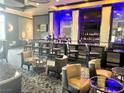 Inviting bar area featuring comfortable seating, a fully stocked bar, and modern lighting at 211 E Flamingo Rd # 1704, Las Vegas, NV 89169