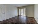 Open living room with tile floors, a door to a closet, and sliding glass doors to the patio at 2120 Ramrod Ave # 415, Henderson, NV 89014