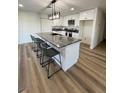 Bright kitchen features white cabinets, stainless appliances, a gray countertop, and island seating at 2413 Valparaiso St, Las Vegas, NV 89108