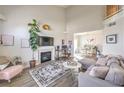 Bright living room featuring high ceilings, fireplace, and modern decor adjacent to the dining area at 2609 Orchard Meadows Ave, Henderson, NV 89074