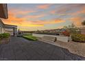Paver patio featuring a putting green and a view of the surrounding desert landscape at 2920 Foxtail Creek Ave, Henderson, NV 89052