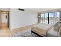 Bedroom features a large balcony, plush rug, and neutral color palette at 3111 Bel Air Dr # 5F, Las Vegas, NV 89109