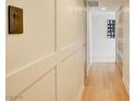 Bright hallway features custom-paneled walls, hardwood flooring, and recessed lighting at 3111 Bel Air Dr # 5F, Las Vegas, NV 89109