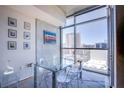 Modern dining area with floor-to-ceiling windows offering city views and seating for four at 353 E Bonneville Ave # 905, Las Vegas, NV 89101