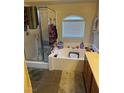 Bright bathroom with a glass shower, tub, and neutral-toned vanity, offering a relaxing space at 4650 Ranch House Rd # 64, North Las Vegas, NV 89031
