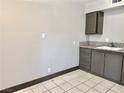 Galley kitchen featuring tiled flooring, neutral walls, and modern cabinets at 520 S 13Th St # D17, Las Vegas, NV 89101