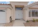 Inviting entrance with double doors, covered porch, and neutral exterior paint at 580 Kenerly St, Henderson, NV 89015